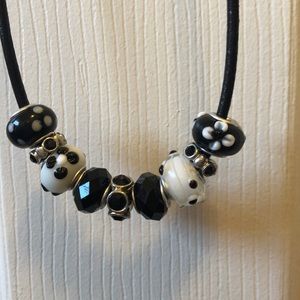 Black leather necklace with black and white charms
